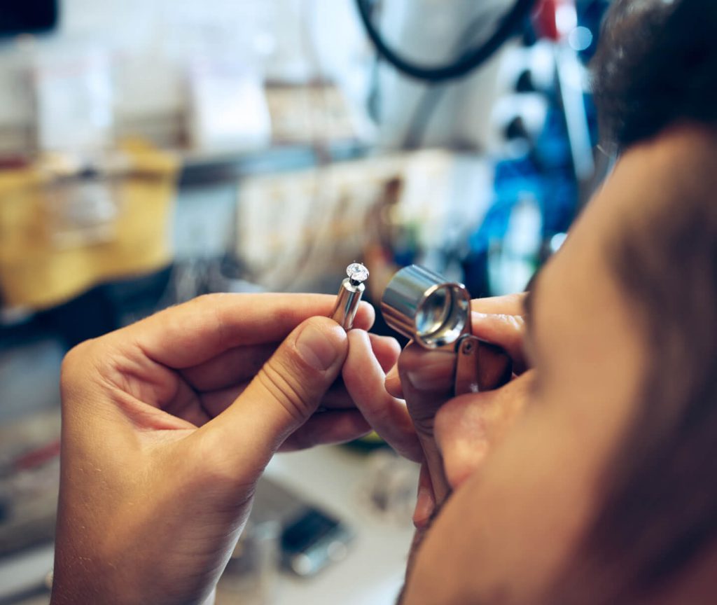 Gemologist examining a stone through a loupe